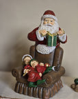 Babbo natale con poltrona e bimbi 17x13x18 cm